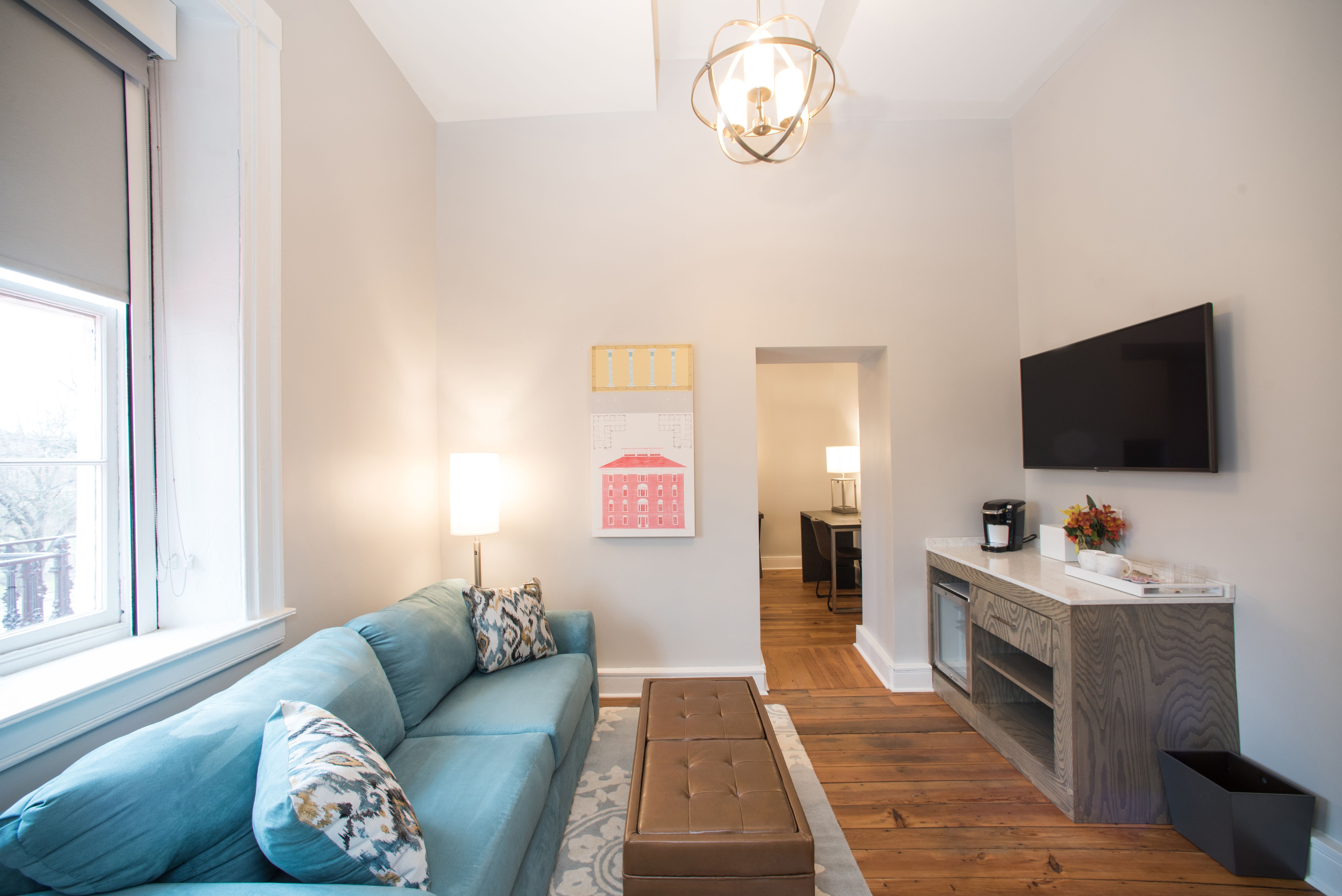 Image of the Queen Suite Living Area with couch and TV. The Blackburn Inn & Conference Center, a member of Historic Hotels since 2018, dates to 1828. It is located in Staunton, Virginia.